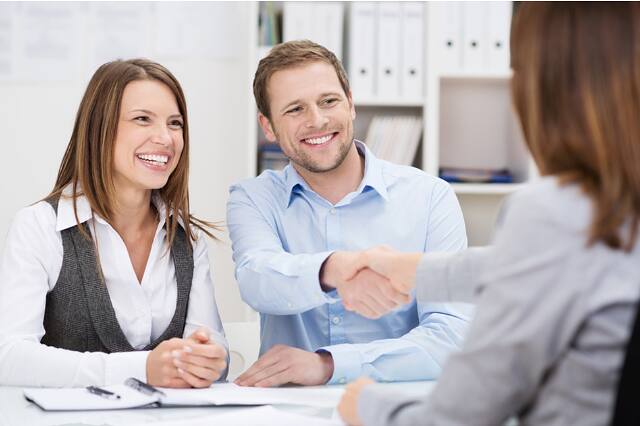Clients shaking hands with their accountant after a meeting
